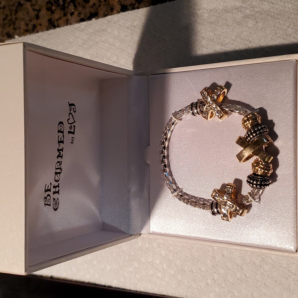 Brand new in box be charmed stretch bracelet.  Gold tone.  8 inches